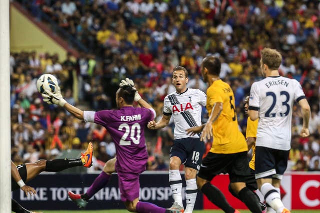 Harry Kane, centre, scores his first goal during the AIA Cup match between Tottenham Hotspur and a Malaysia XI at Shah Alam stadium