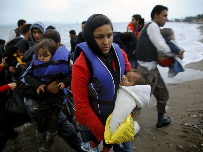 Afghan immigrants land at a beach after landing in a dinghy