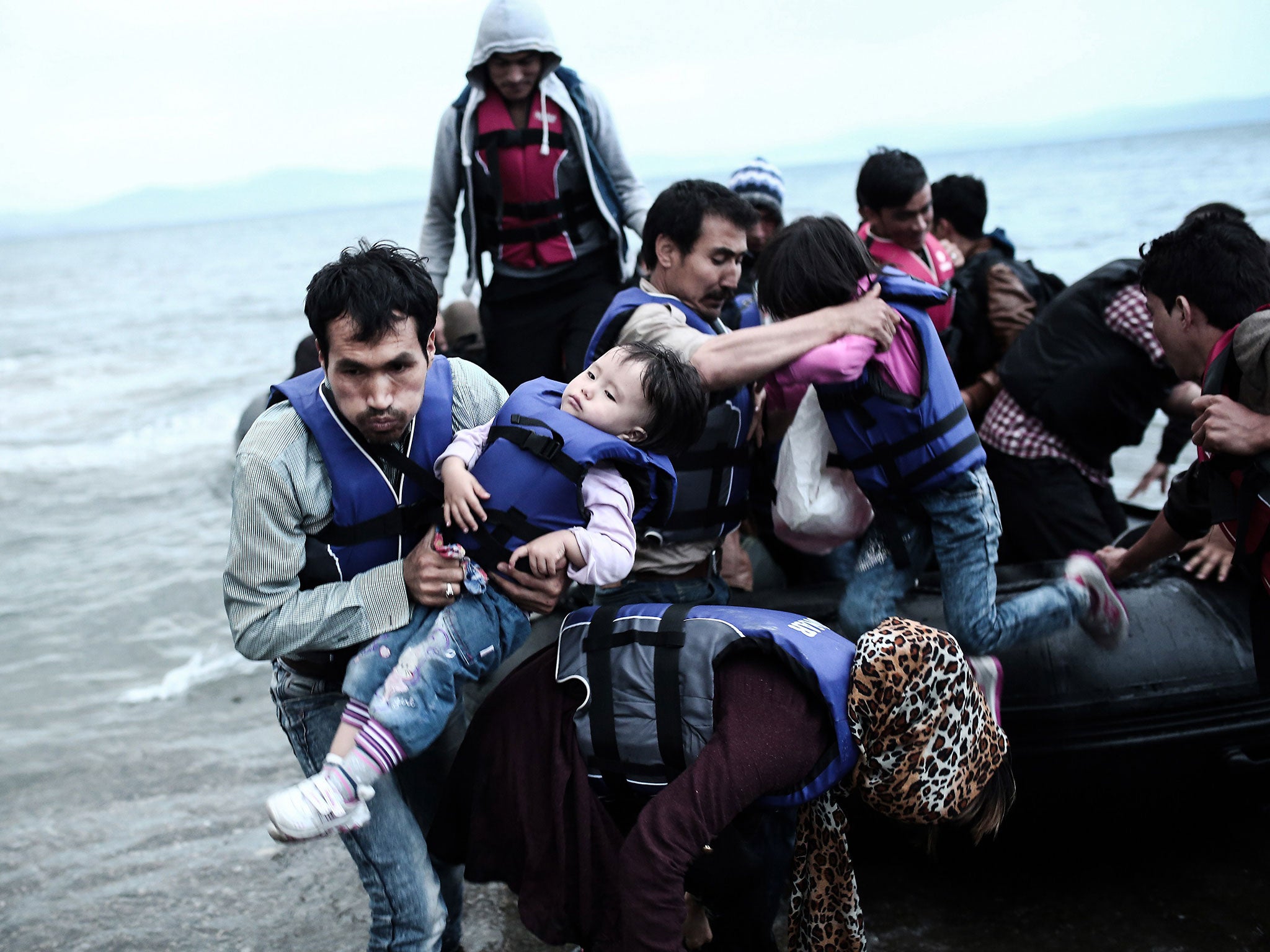 Afghan migrants arrive on a beach of Kos