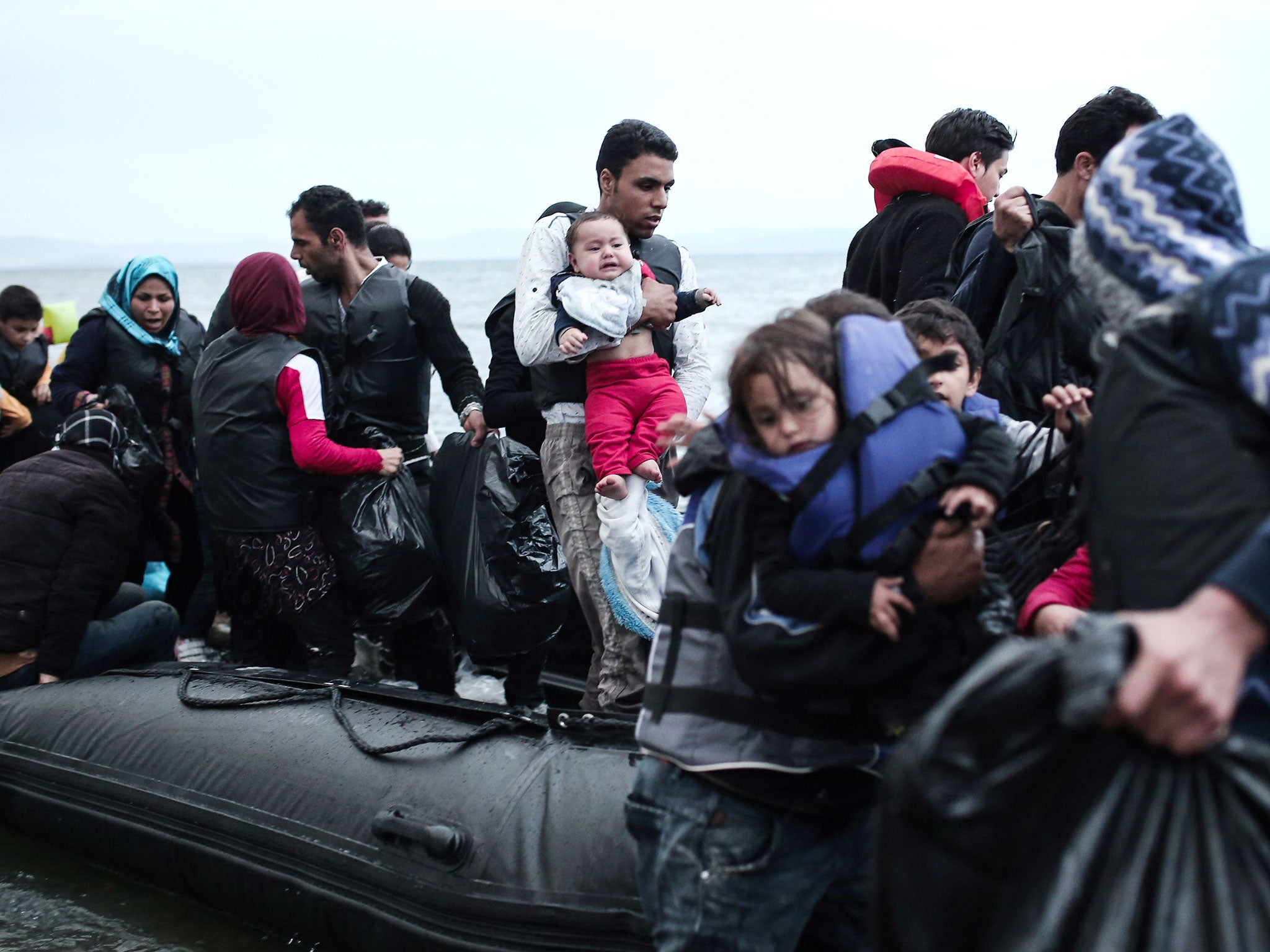 Afghan migrants arrive on a beach of Kos