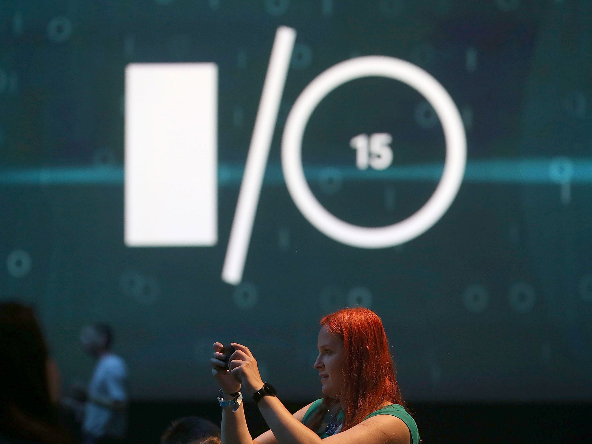 Attendees take photographs before the start of the opening keynote during the 2015 Google I/O conference
