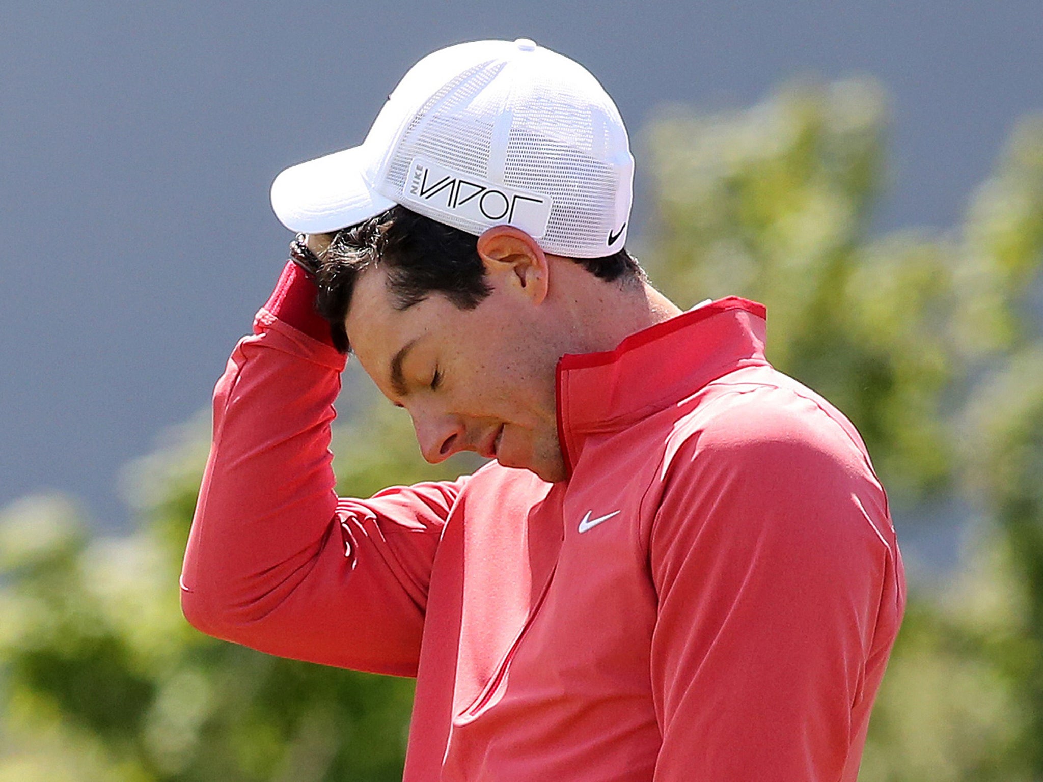 Rory McIlroy reacts after missing a putt on the ninth