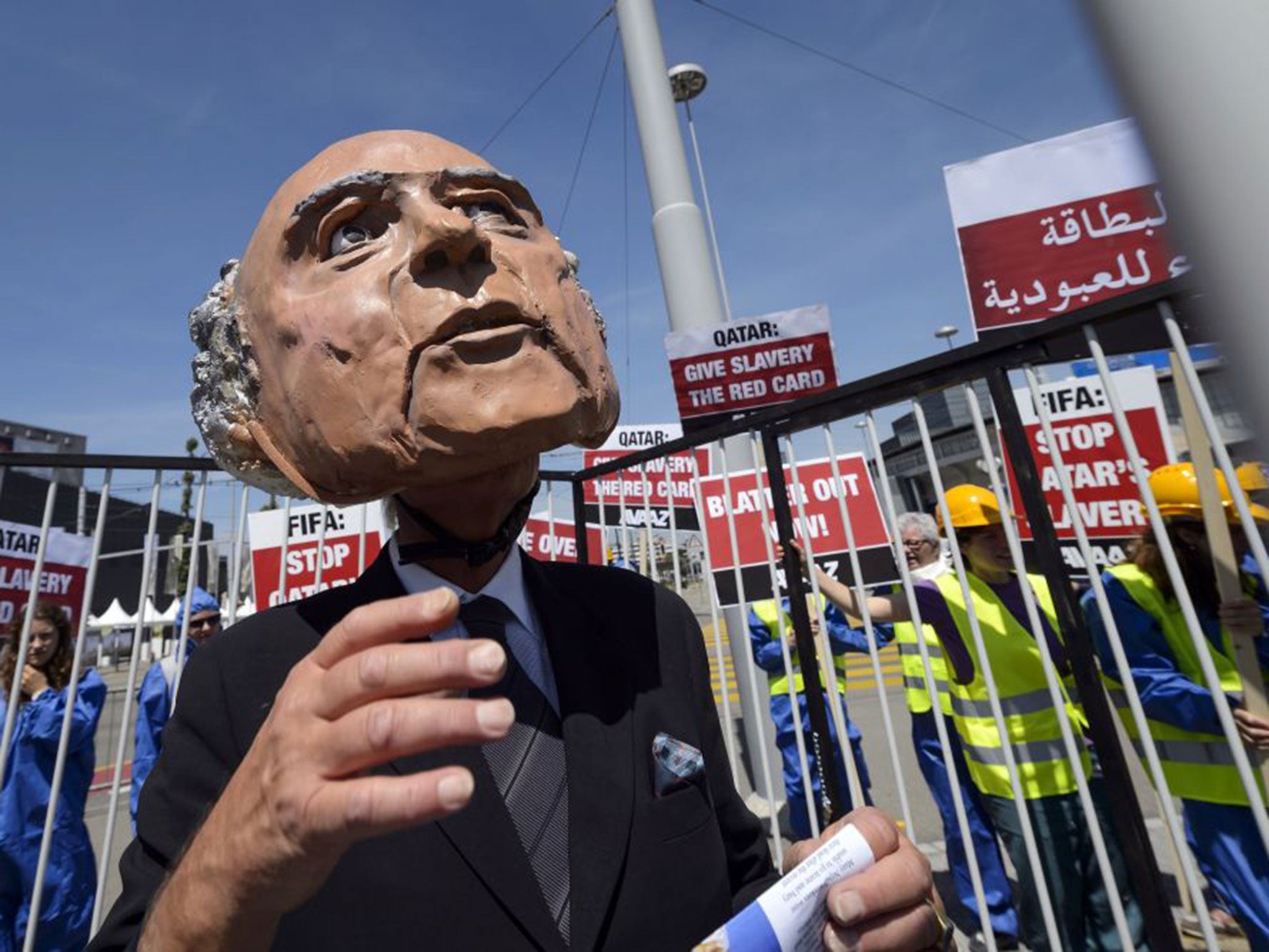 A protester disguised as Sepp Blatter takes part in a demonstration against the condition of workers in Qatar outside the Fifa Congress in Zurich