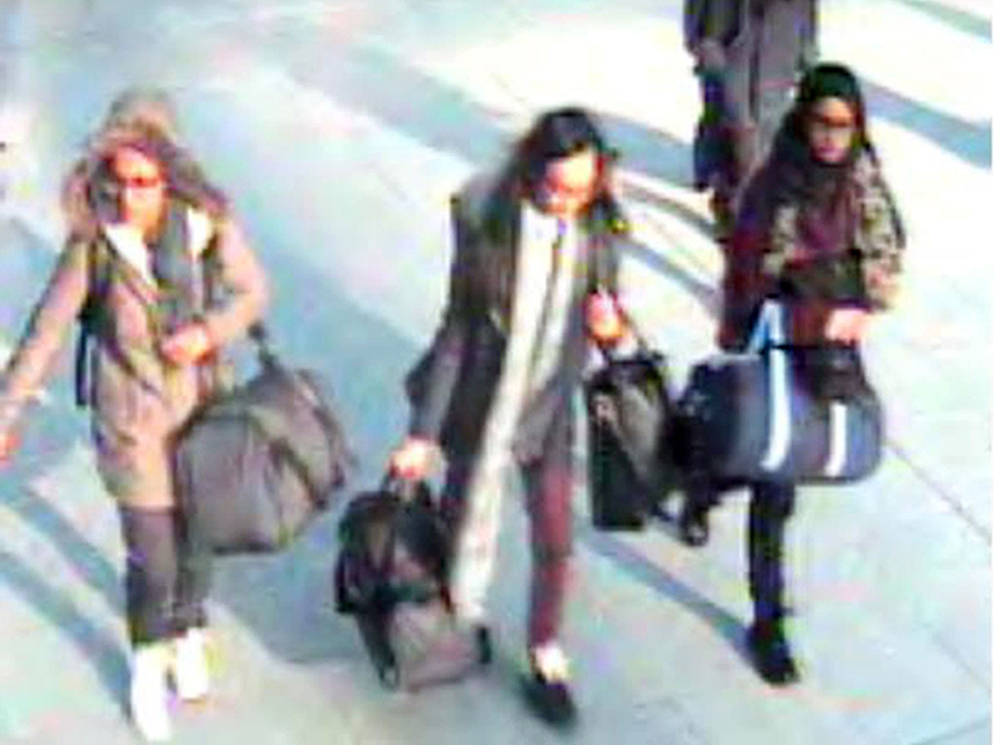 CCTV still of 15-year-old Amira Abase, left, Kadiza Sultana,16, center, and Shamima Begum, 15, walk through Gatwick airport before travelling to Syria