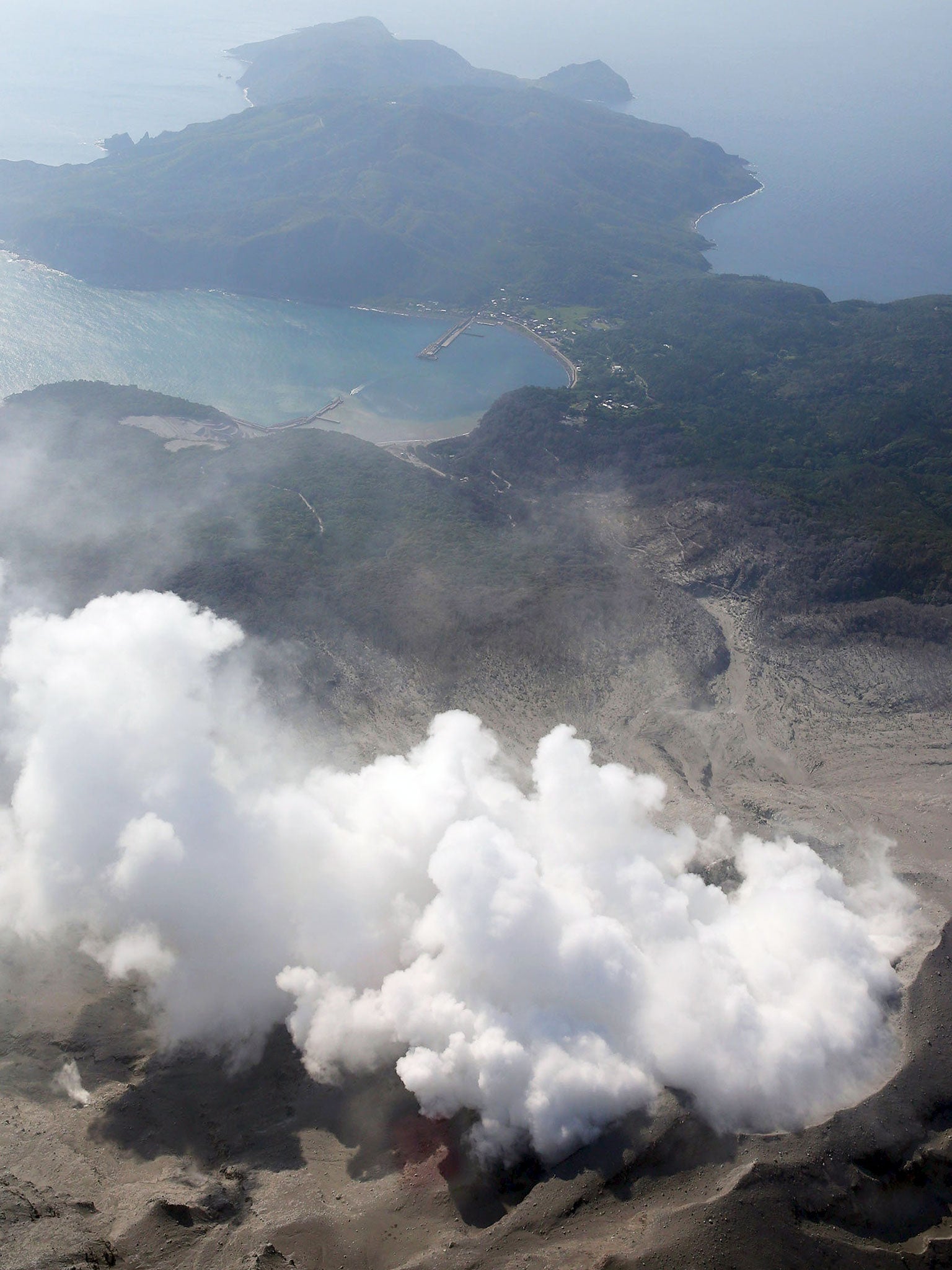 Smoke spews from the erupting crater of Mount Shindake on Kuchinoerabujima island, Kagoshima Prefecture