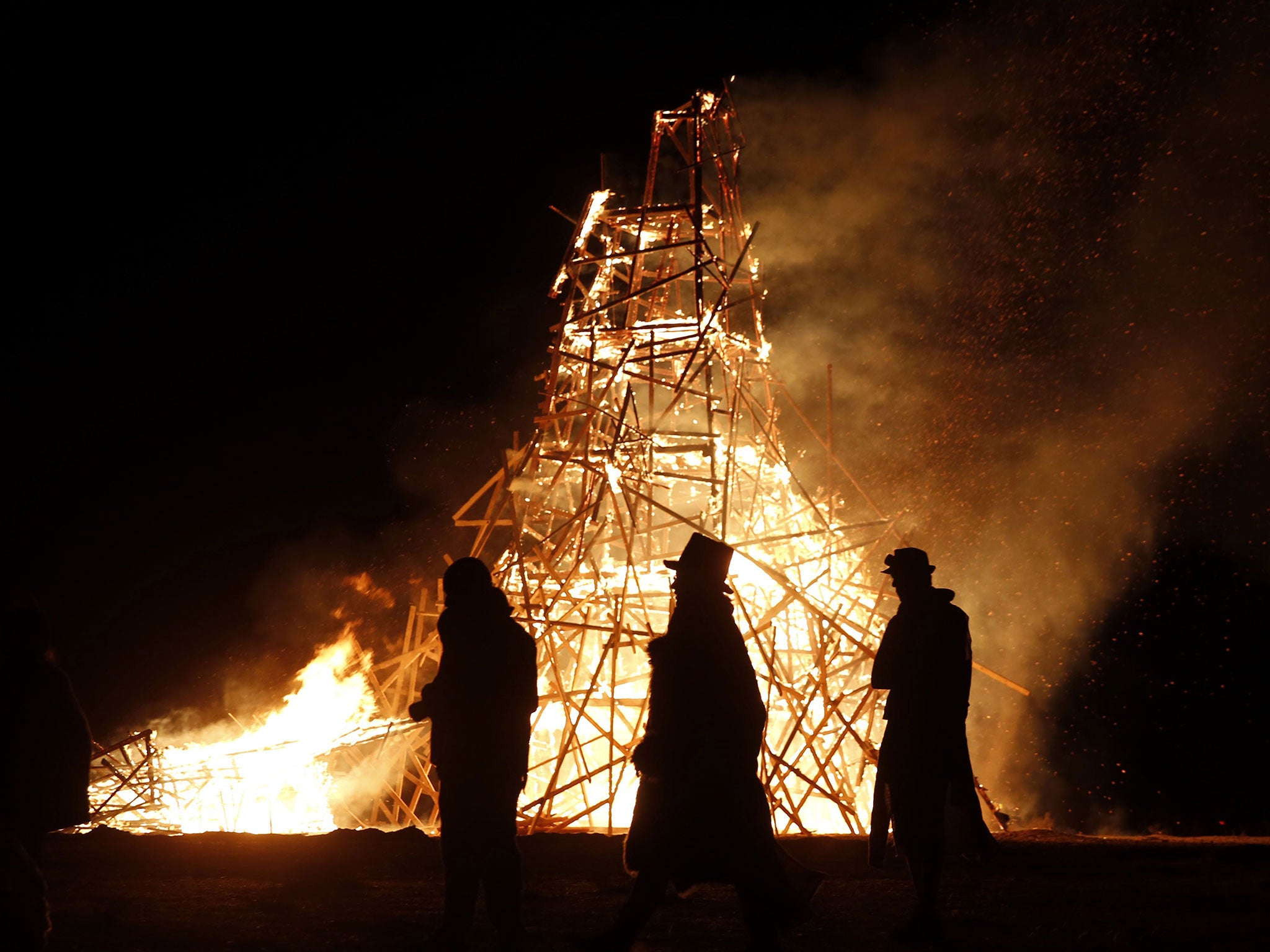 A wooden effigy is burned at the 2015 Midburn festival in Israel