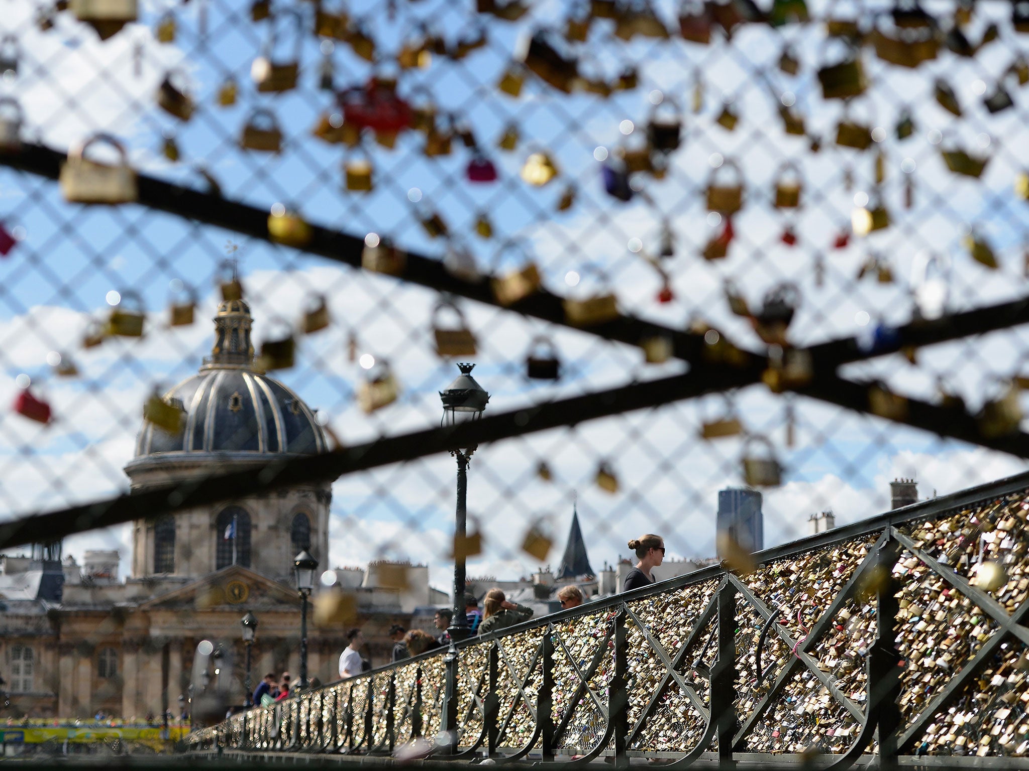 Lovers visiting Le Pont des Arts in Paris have left thousands of padlocks engraved with their initials