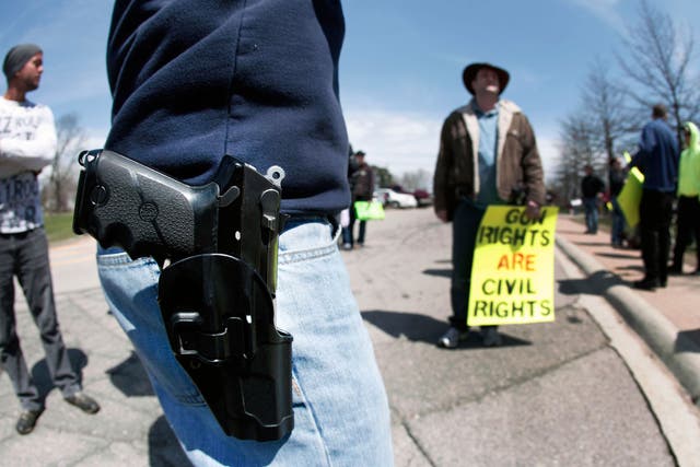 A supporter of Michigan's Open Carry law attends a rally and march April 27, 2014 in Romulus, Michigan.