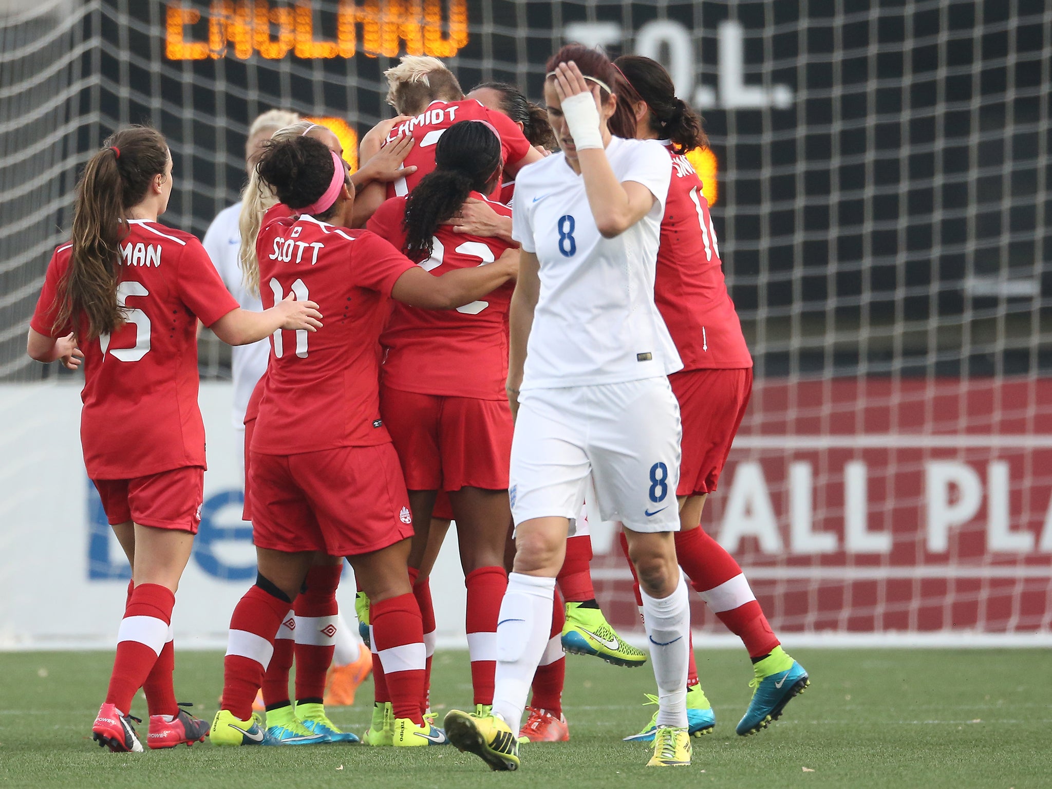 Sophie Schmidt celebrates with her Canadian team-mates as Jill Scott reacts to conceding