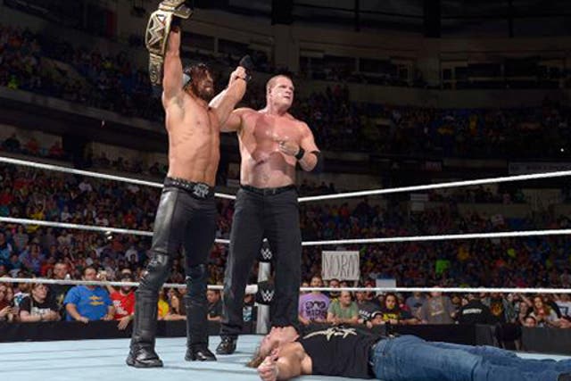 Seth Rollins and Kane stand tall over a motionless Dean Ambrose