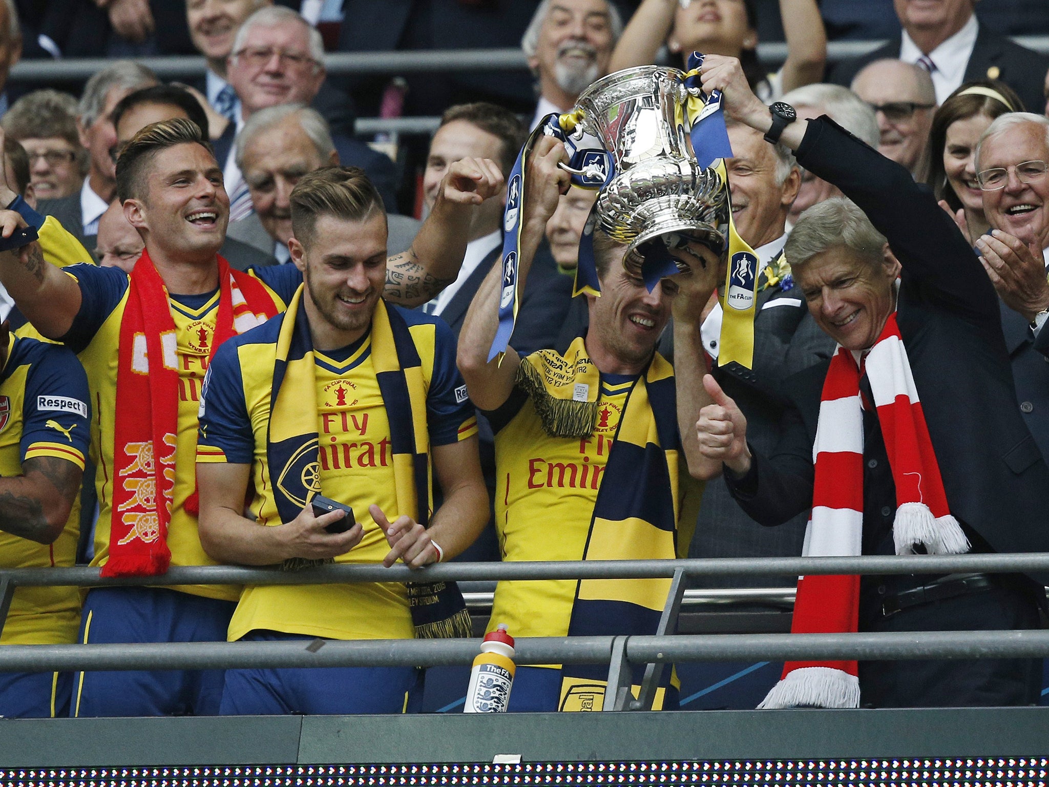 Arsene Wenger lifts the FA Cup trophy for the second year running