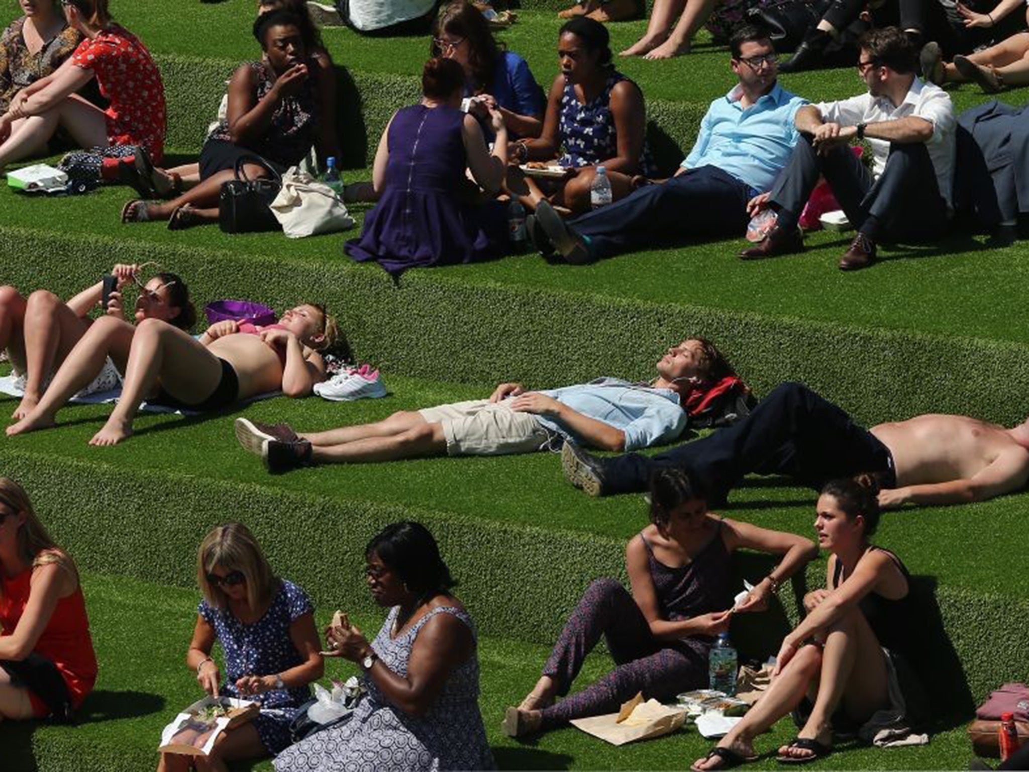 Londoners relax in an area next to the Regent's Canal at King's Cross lastin July 2014.