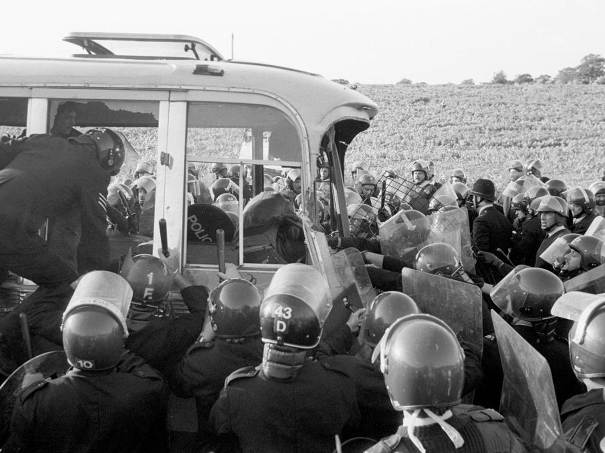 Stonehenge Protest. An army of police surround the last coach to be stopped from racing round the field near Stonehenge where violence erupted this evening.