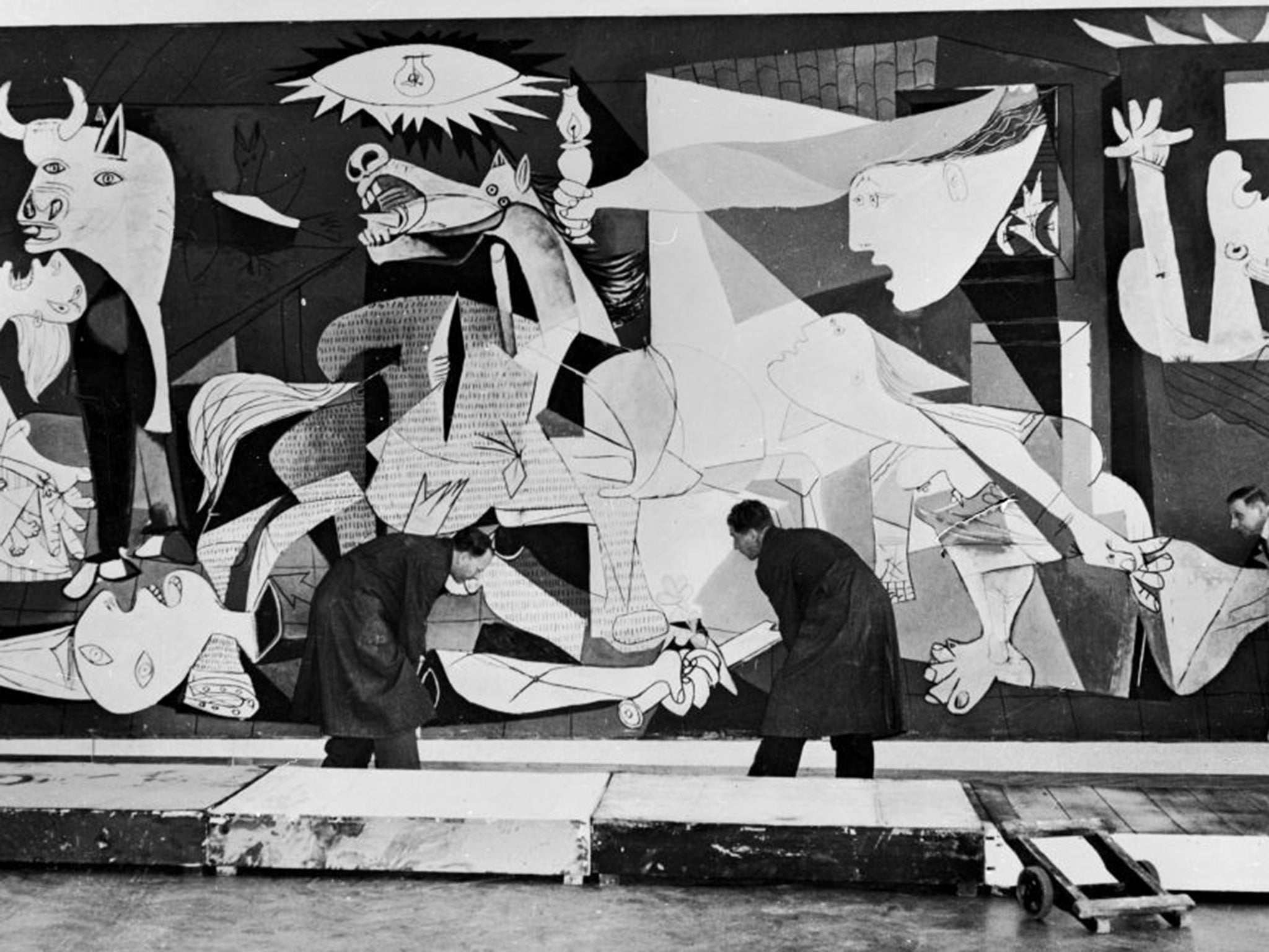 Guernica, perhaps the most famous painting by Pablo Picasso, being hung in the Municipal Museum in Amsterdam for an exhibition.