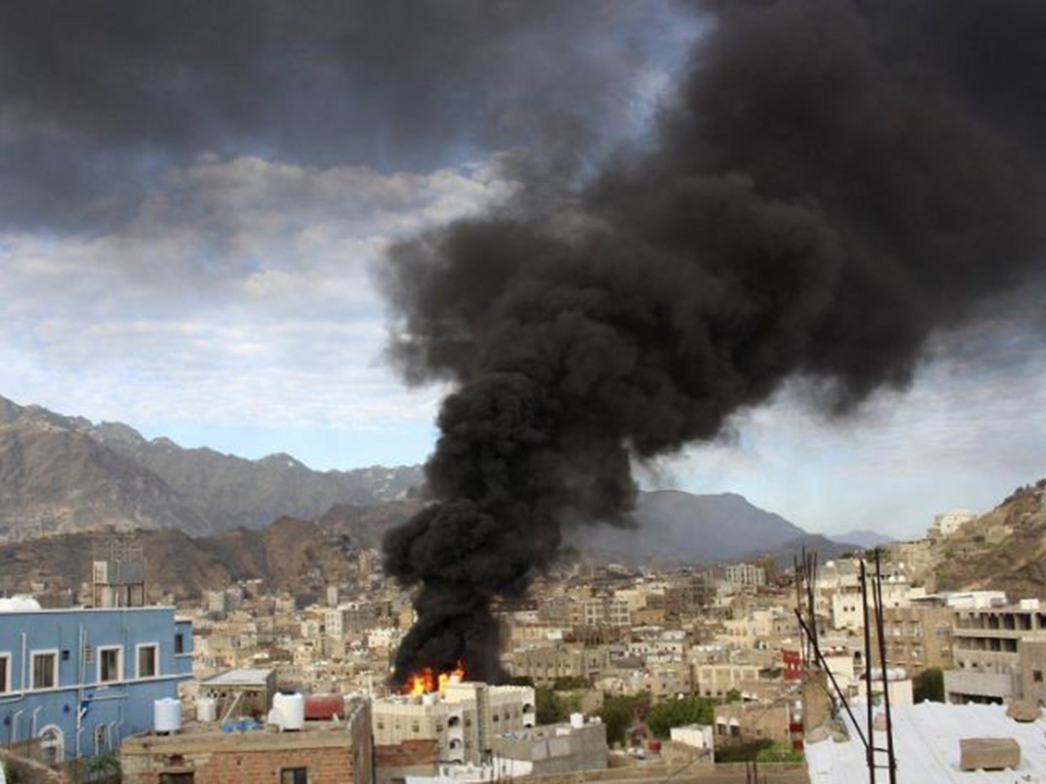 Smoke billows from a burning fuel truck after it was set ablaze during clashes between Houthis and fighters of the Popular Resistance Committees in Yemen's southwestern city of Taiz.
