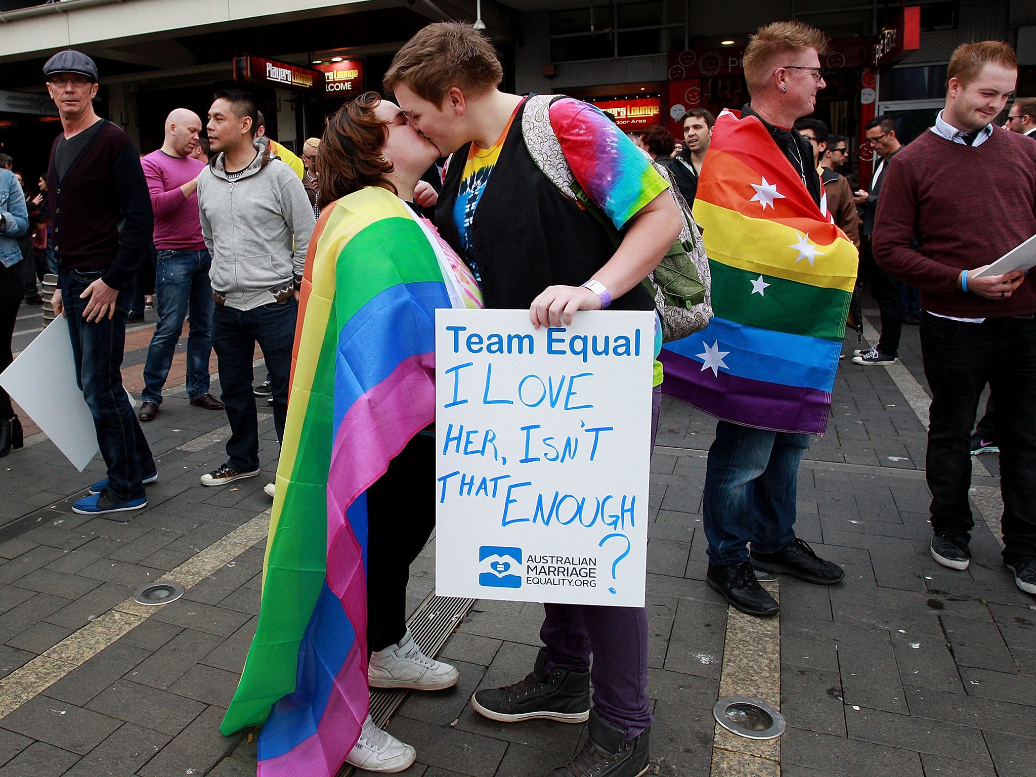 Demonstrators in Sydney kiss during the rally in support of equal marriage