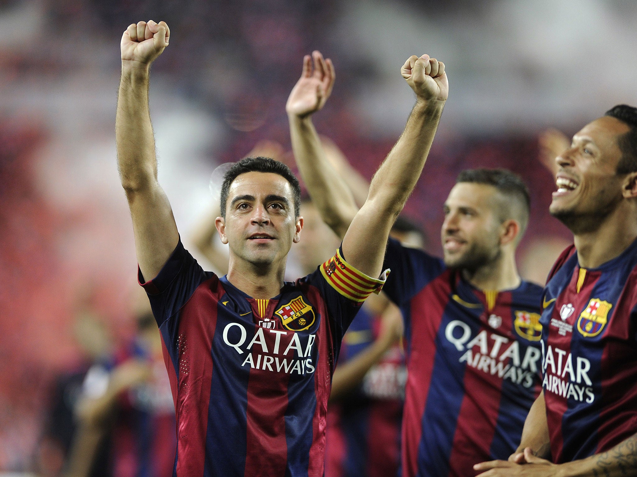 Xavi salutes the crowd on his final appearance at the Nou Camp