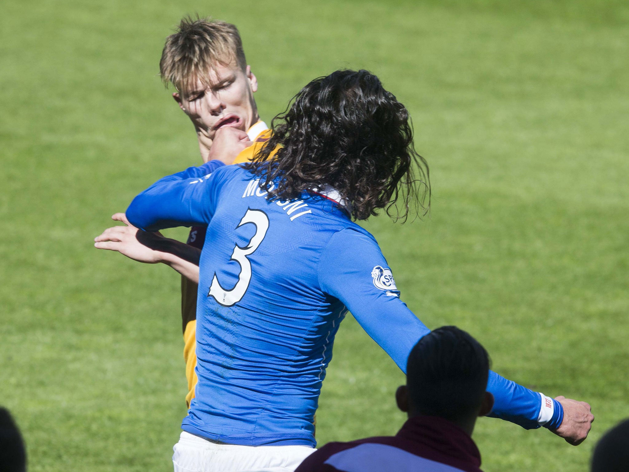 Bilel Mohsni, of Rangers, punches Motherwell’s Lee Erwin sparking a scuffle between staff and players from both teams