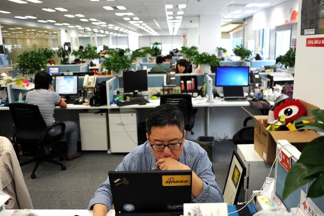 This picture taken on April 16, 2014 shows a man using a laptop at an office of Sina Weibo, widely known as China's version of Twitter, in Beijing