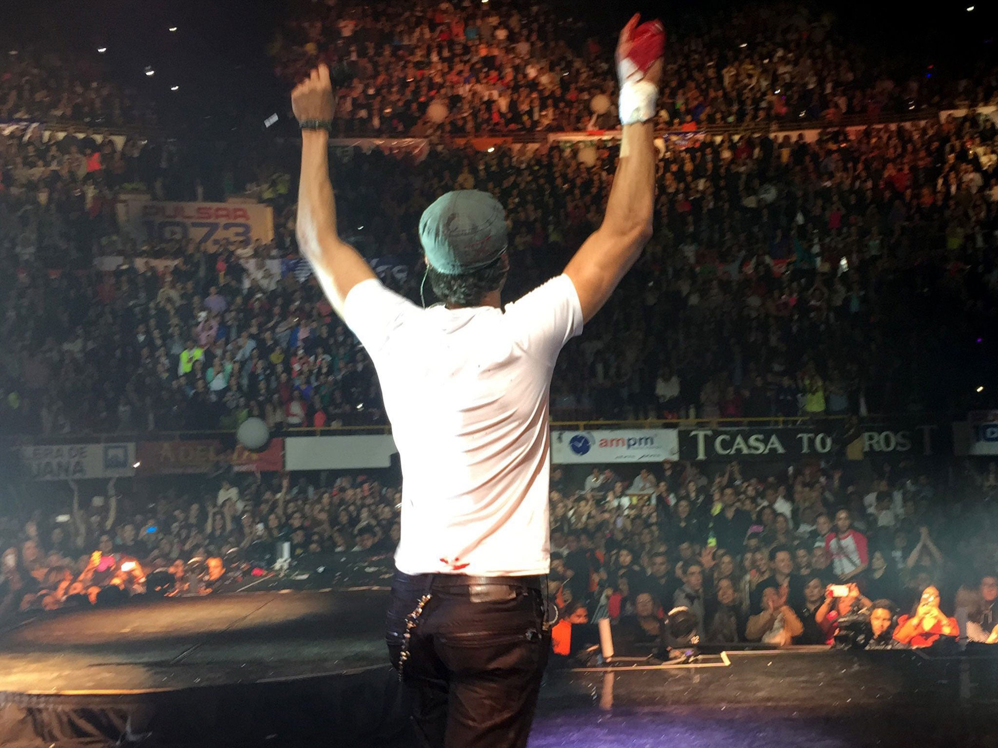 Enrique Iglesias performing on stage after suffering an accident with a drone on his right hand, during a concert in Tijuana, Mexico