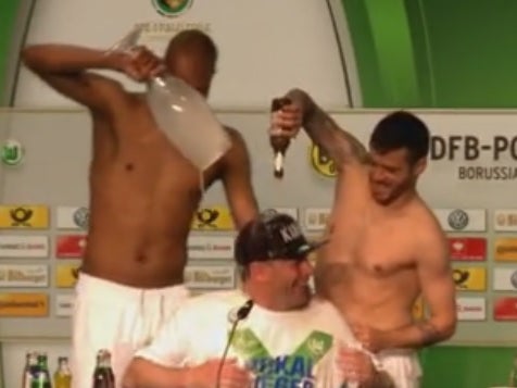 Naldo and Vieirinha give manager a beer-shower.