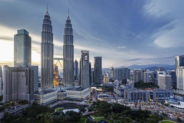 The Petronas Twin Towers rise above the city