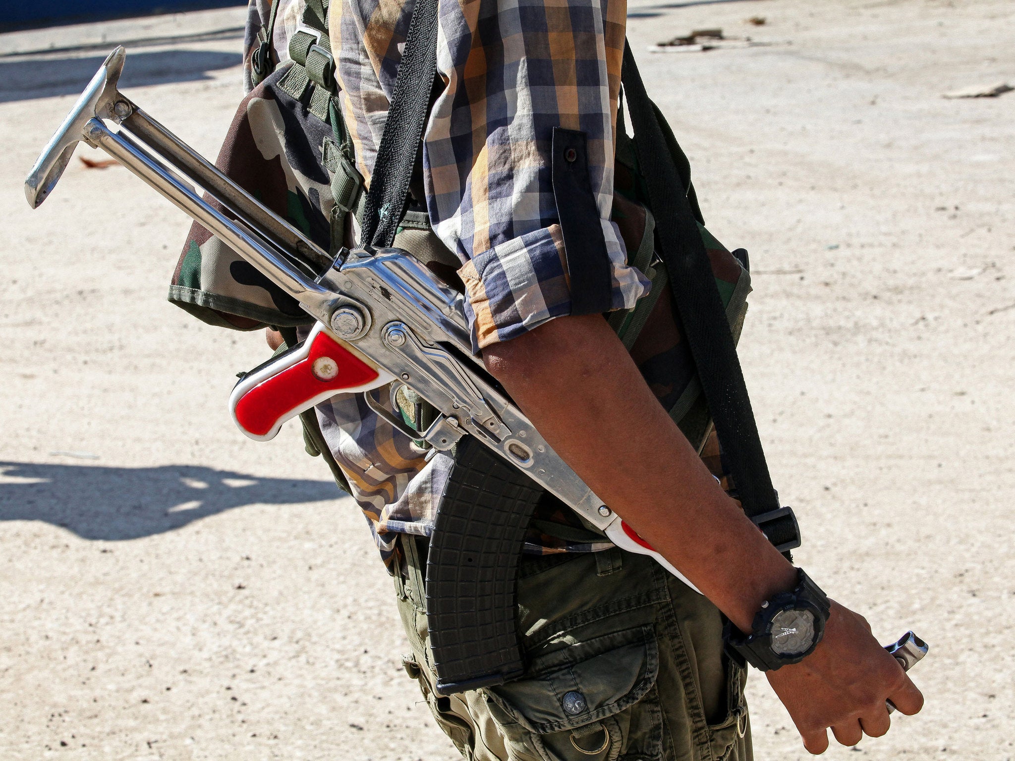 A fighter with the Kurdish People's Protection Units stands in the streets of Kobane