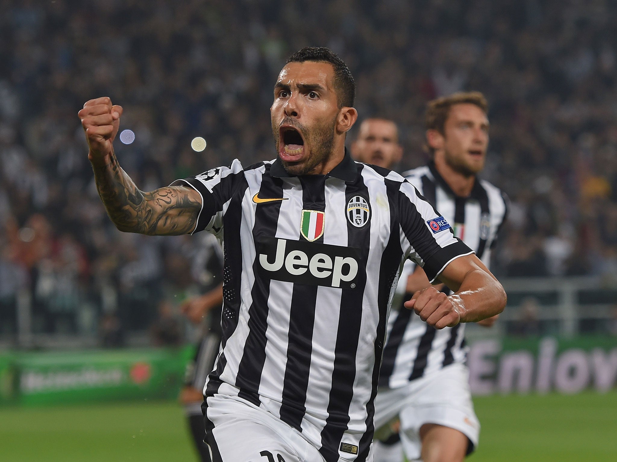 Carlos Tevez celebrates scoring against Real Madrid in the first leg