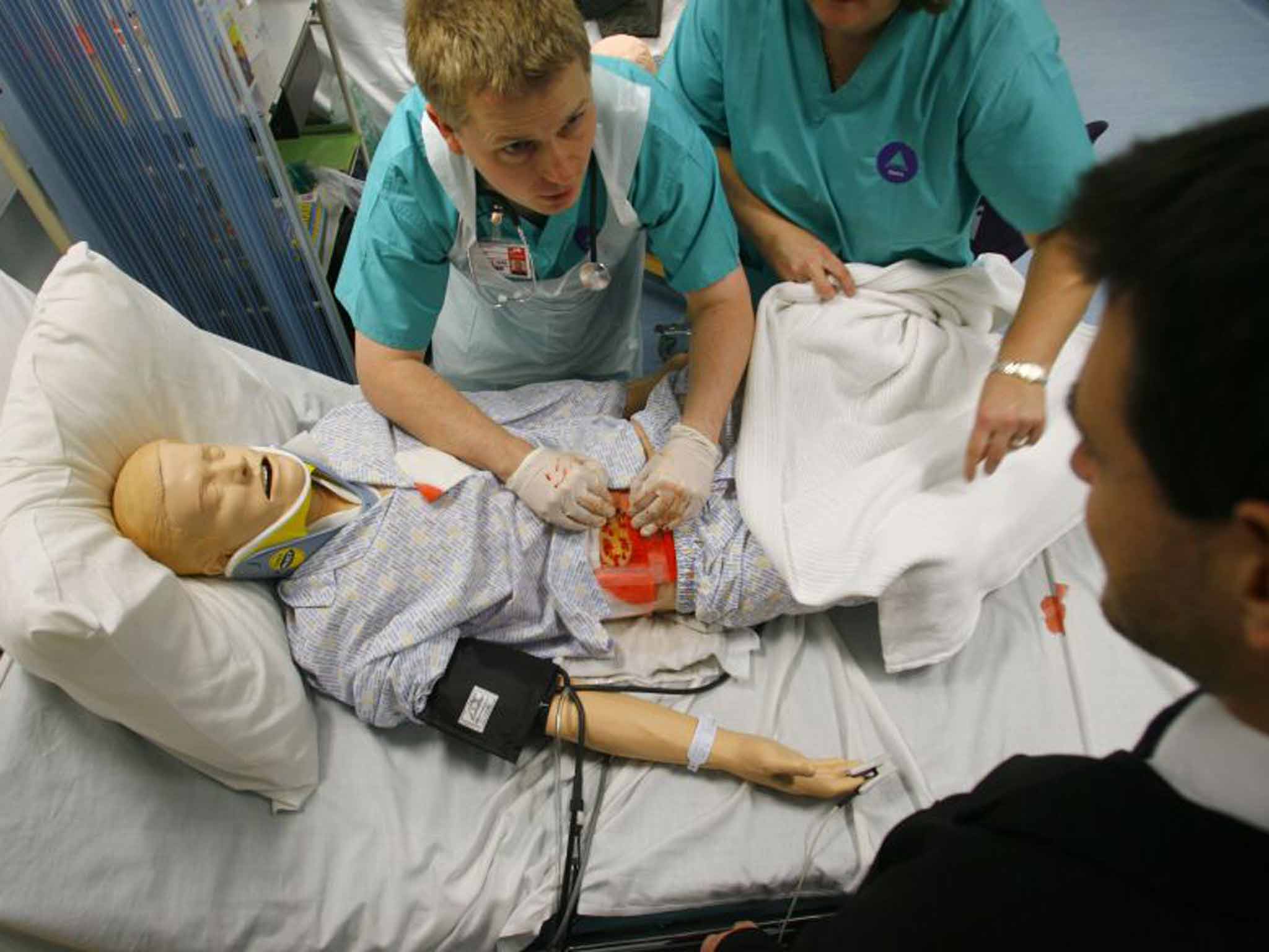 Model student: a trainee doctor dresses a wound on a computerised mannequin
