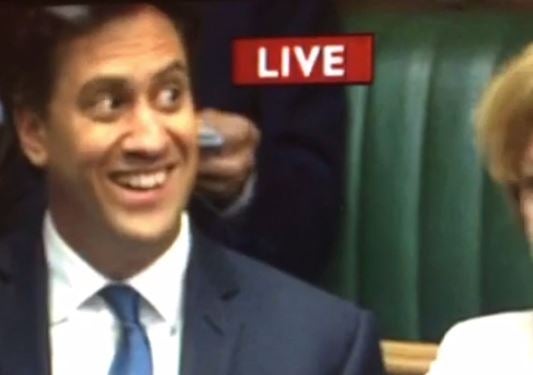 Ed Miliband catches the eye of a colleague as he returns to the backbenches for the first time since his election defeat
