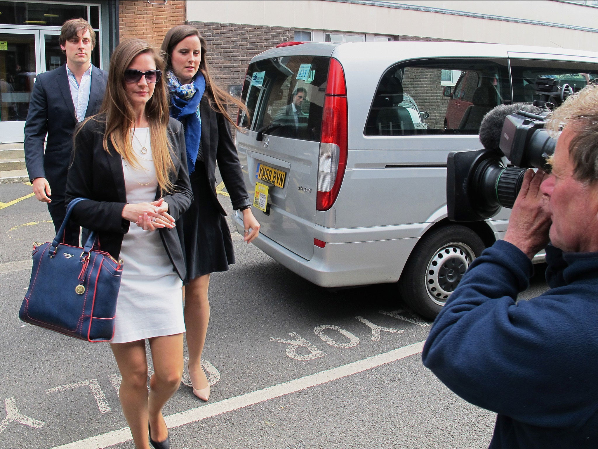 The widow of Cpl James Dunsby, Bryher Dunsby, centre, arrives at Solihull Council offices for the start of a four-week inquest into the death of her husband and two other Army reservists after a special forces test March in 2013