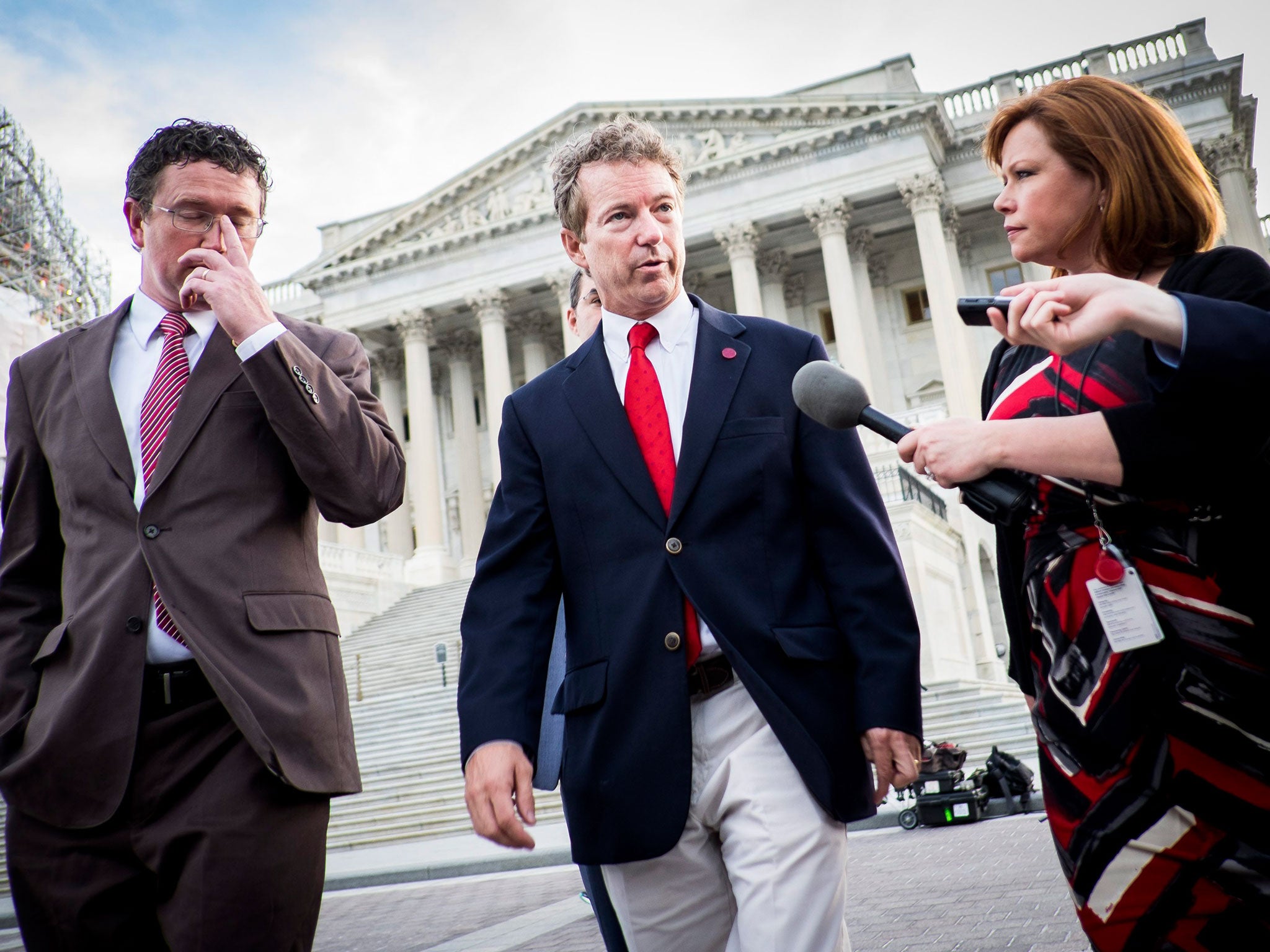 Senator Rand Paul, centre, emerges from the Senate in Washington on Sunday after blocking NSA provisions