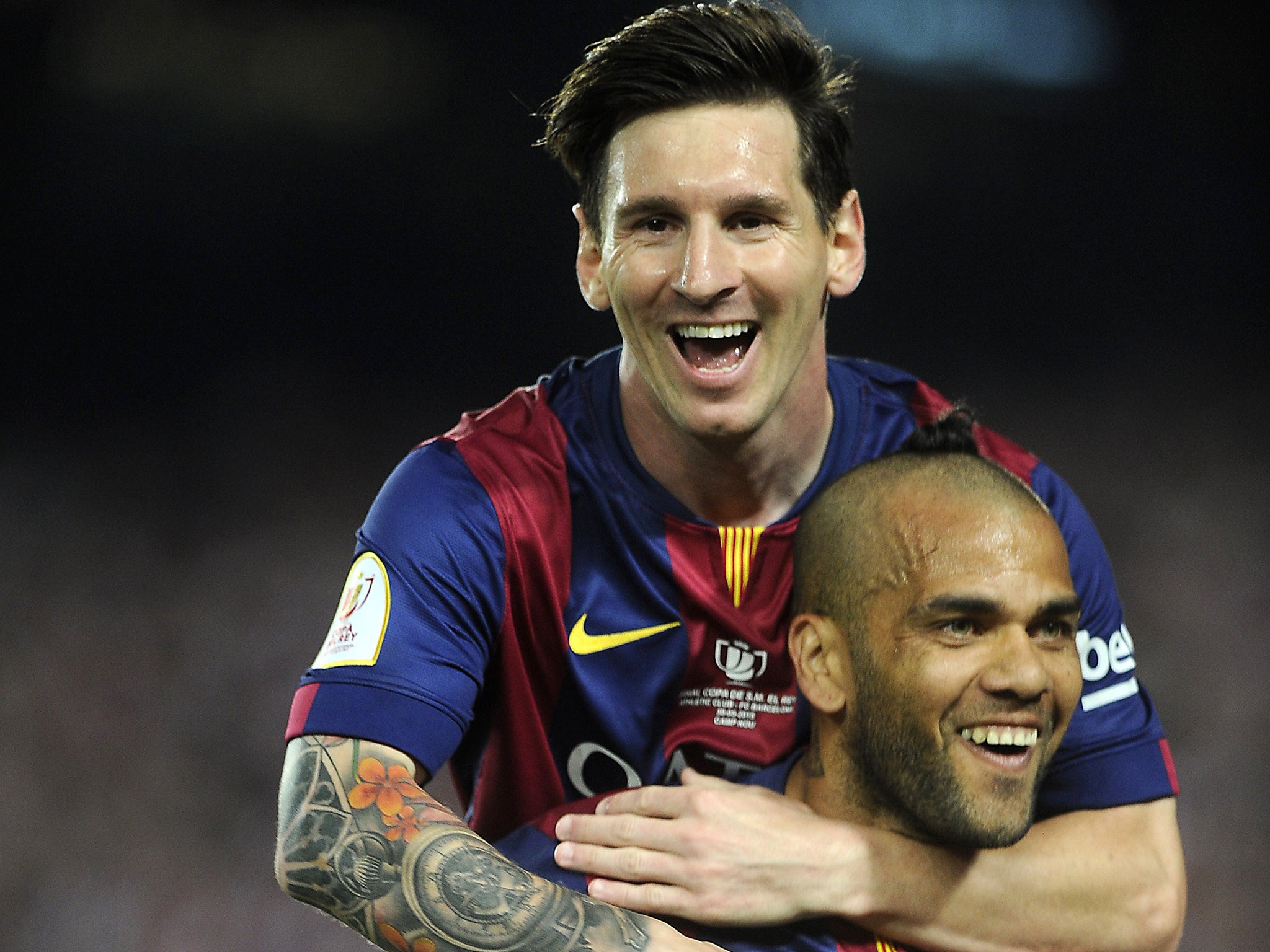 Alves celebrates with Lionel Messi during Saturday's Copa del Rey victory