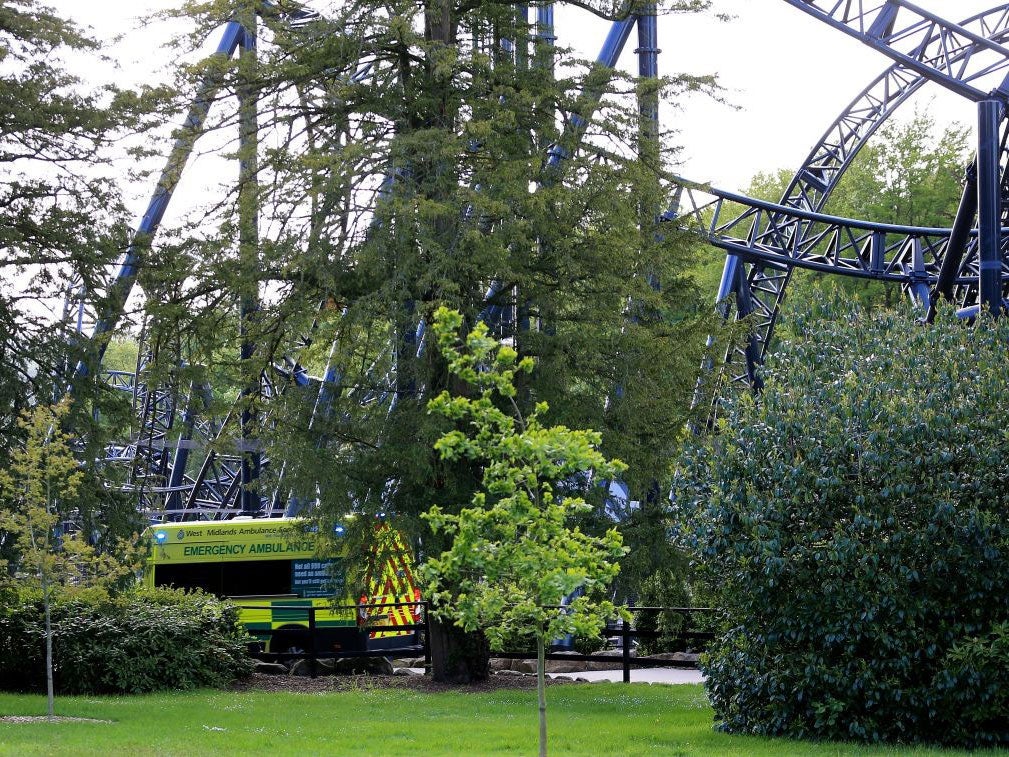 An ambulance driving past The Smiler after the crash