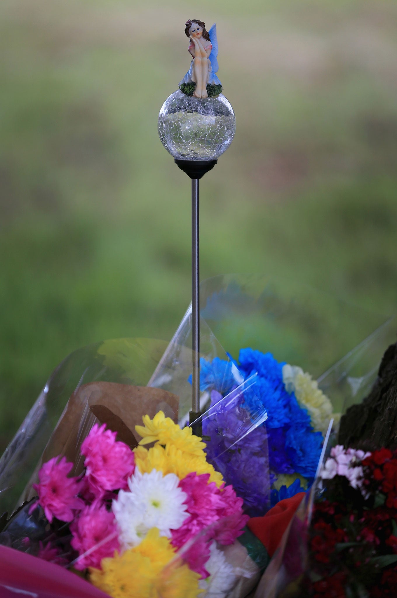 Flowers and a fairy lamp tribute lay at the scene in Westfield Lane, Mansfield, where a body was found last night during the search for missing 13-year-old girl Amber Peat