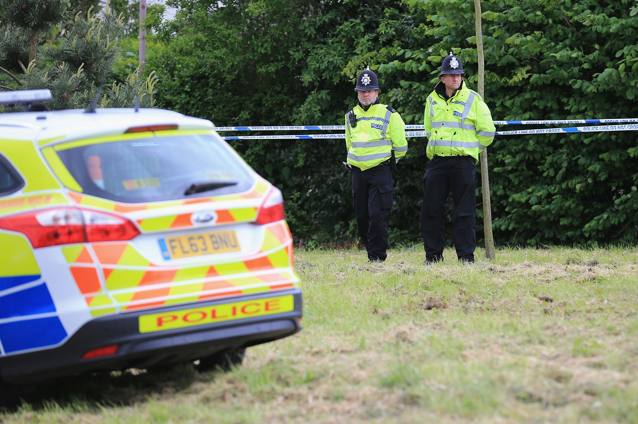 Police guard the area where a body was found during the search for missing teenager Amber Peat