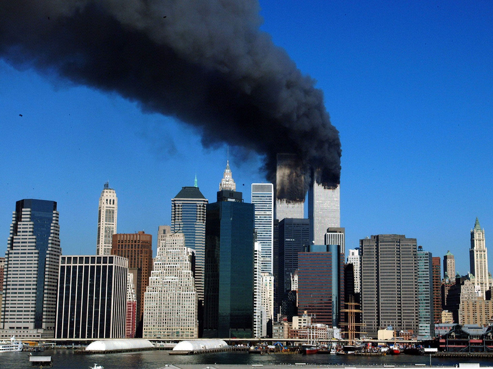 The twin towers of the World Trade Center billow smoke after hijacked airliners crashed into them early 11 September, 2001
