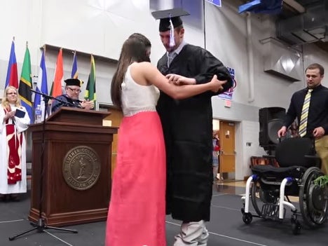 Chris Norton paralysed five years ago, walks on stage to collect diploma