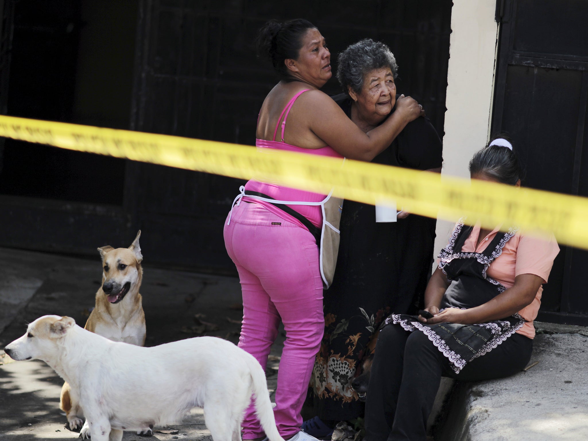 Relatives of Josue David Penalba Rivera react as police secure a crime scene in San Salvador this week.