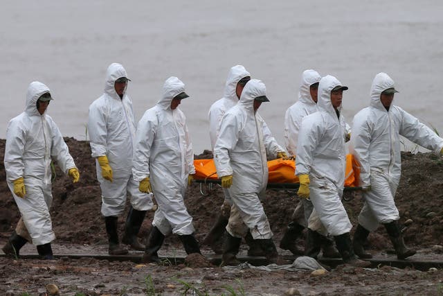 Rescuers carry a victim’s body from the capsized ship in the Yangtze River