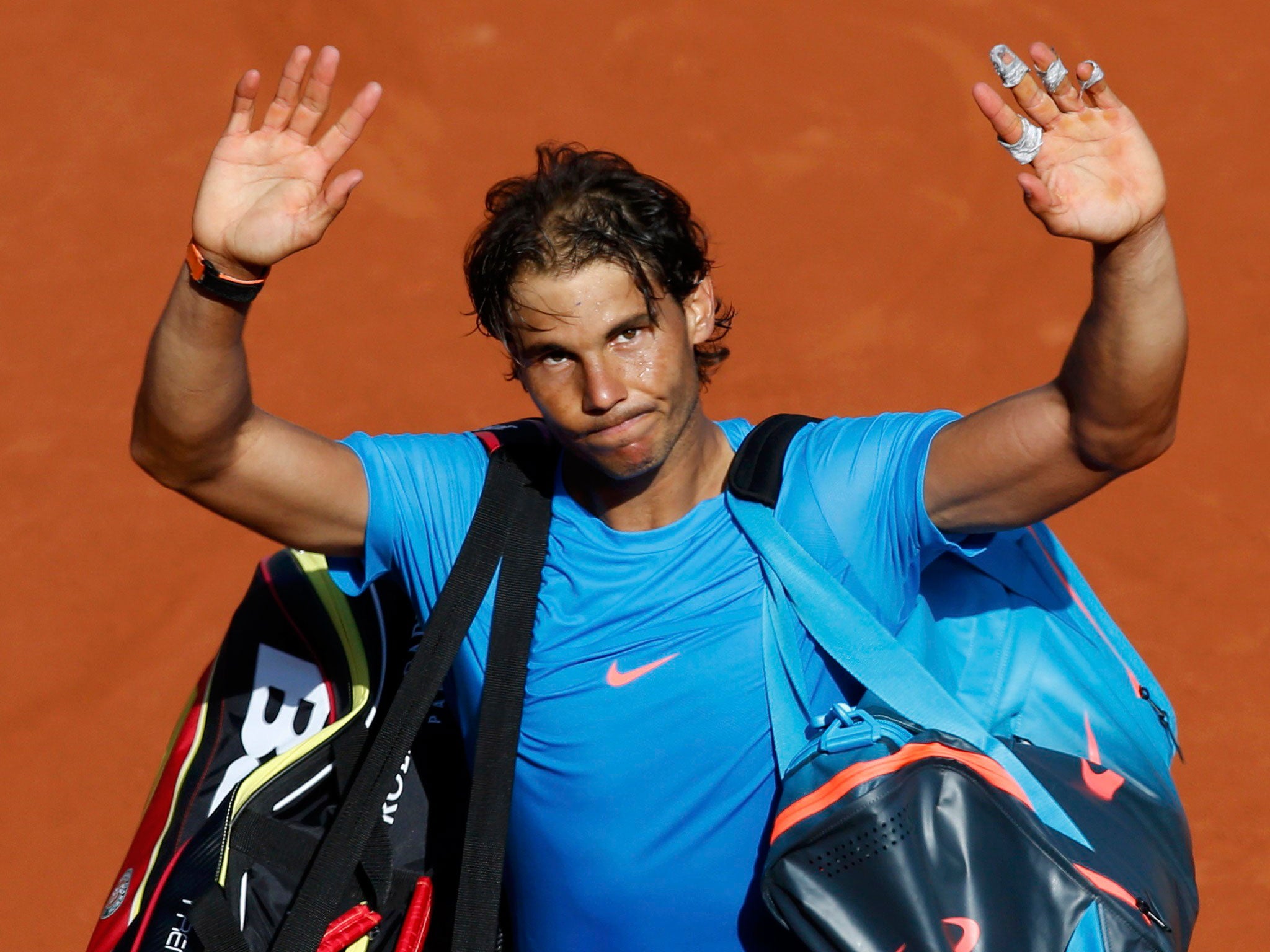 Rafael Nadal waves to the crowd after only his second defeat at Roland Garros