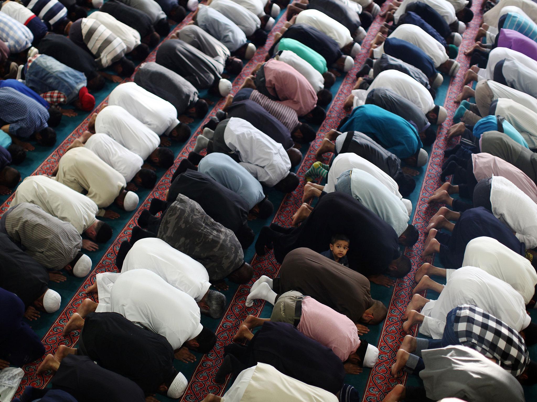 Muslim men pray at the East London Mosque on the last day of Ramadan