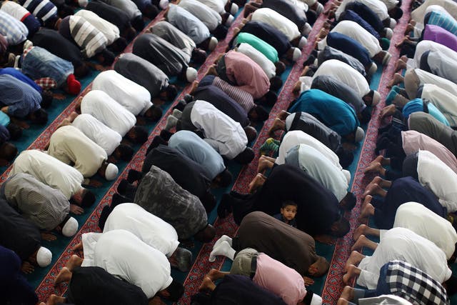 Muslim men pray at the East London Mosque on the last day of Ramadan in 2015