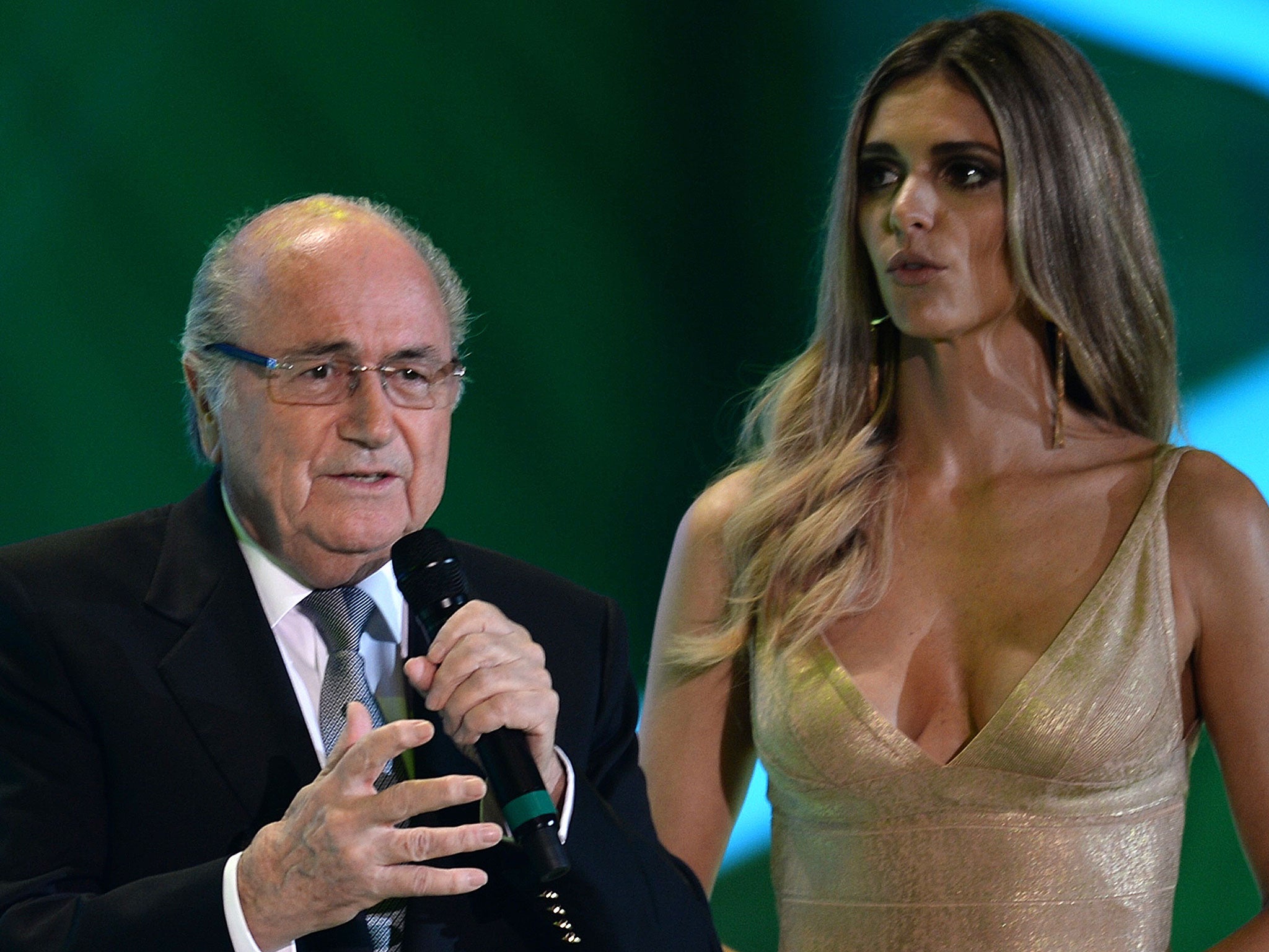 Sepp Blatter (L) speaks next to presenter Fernanda Lima