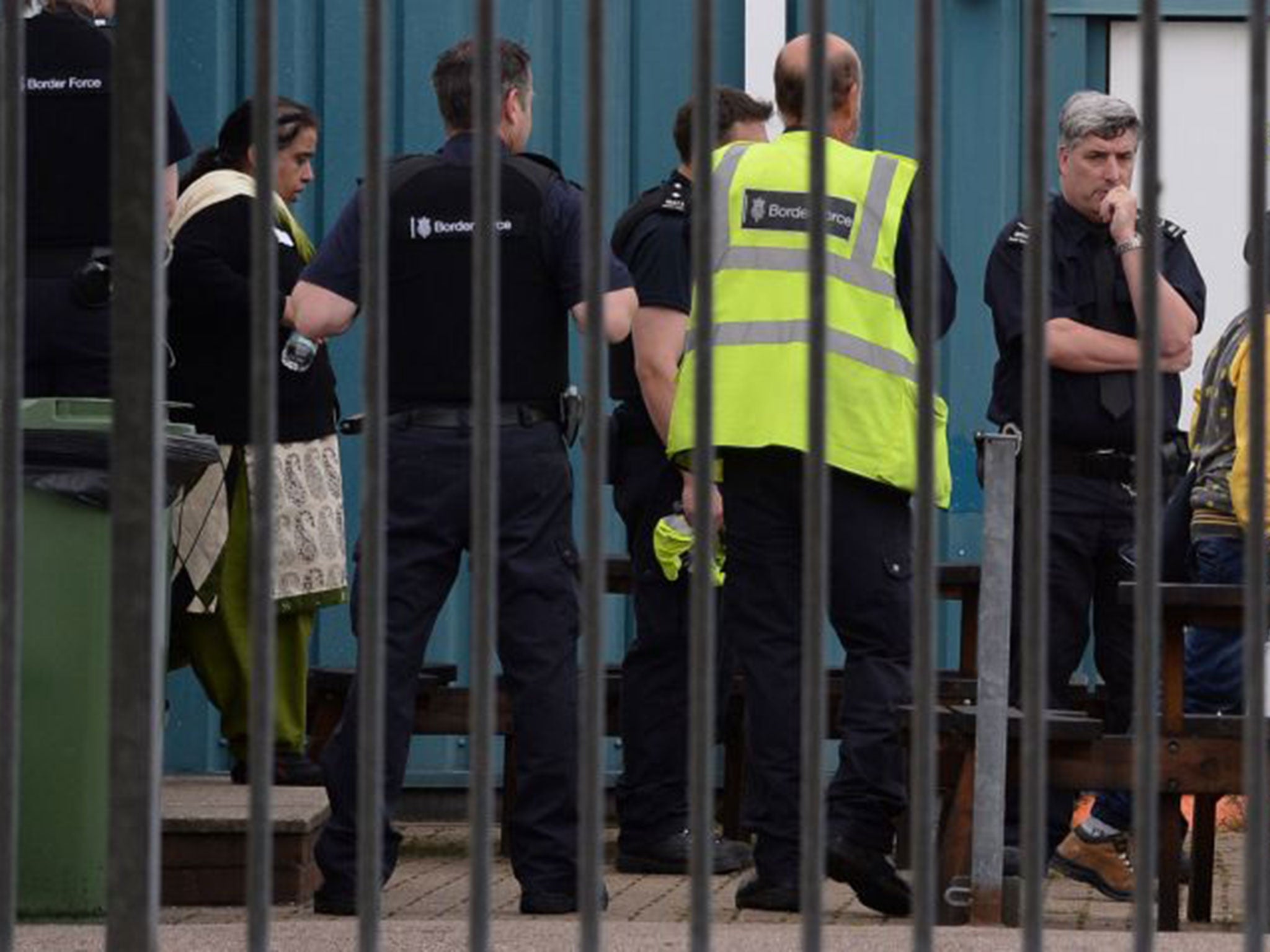 Border Force staff detain some of the 68 people found locked in four lorries at Harwich International Port