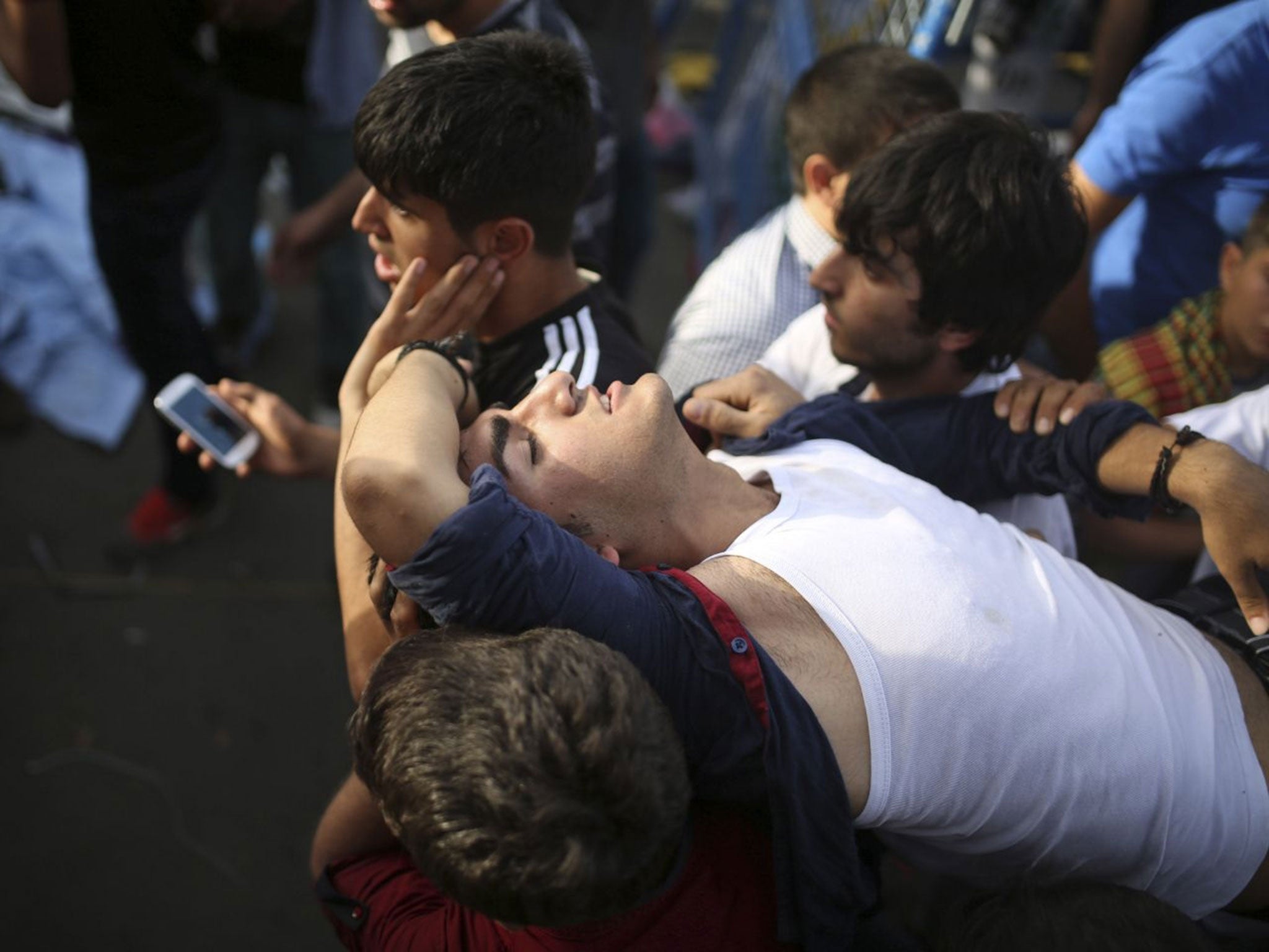 People carry a youth, wounded during an explosion at a pro-Kurdish Peopleís Democratic Party (DHP) rally in Diyarbakir (Image: Emre Tazegul/PA)
