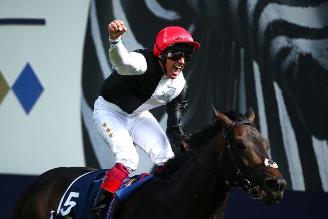 Frankie Dettori raises his fist in the air after the triumph