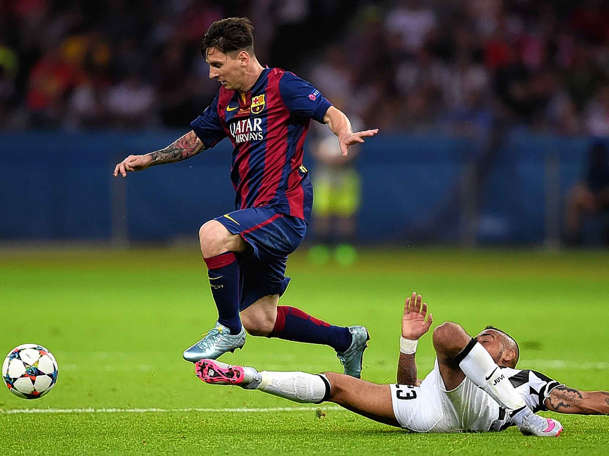 Lionel Messi skips over the challenge of Arturo Vidal