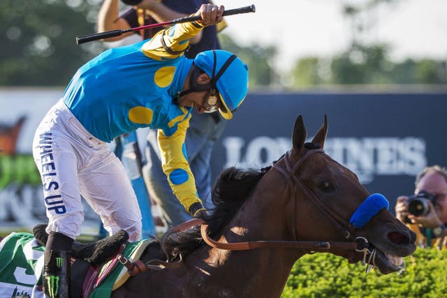 Jockey Victor Espinoza celebrates after winning the 147th running of the Belmont Stakes as well as the Triple Crown aboard American Pharoah