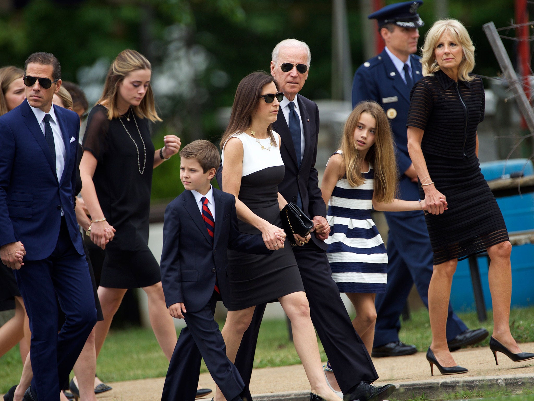 Joe Biden, centre, arrived at his sons funeral with his wife Dr Jill Biden, right